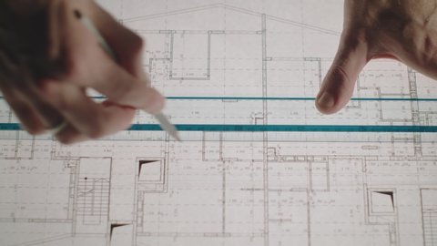 Architect Engineer Makes Drawing. Drawings In Pencil. Hand Draws A Line. Use Of Pencil, Paper And Ruler, Stationery. Planning Of Buildings For Industrial Enterprises, Development Of The Exterior Of