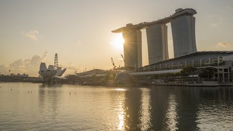 Marina Bay, Singapore - July 6, 2019: 4k hyperlapse time lapse of sunrise at Marina Bay Singapore city skyline. Tilt down