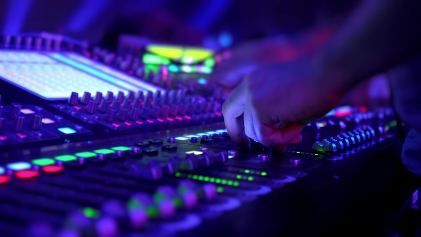 Remote control for adjusting the sound. Audio mixer. Sound engineer adjusts the sound. Music Festival. Change the volume level. Recording studio. Shooting a television show, a concert. Live broadcast. Royalty-Free Stock Footage #1034111072