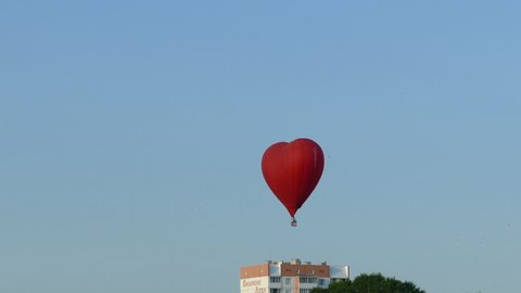 Aeronautics  Compete. Balloons soar in the evening sky