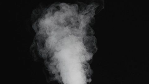 Slow motion of water vapor stream comes from below over black background