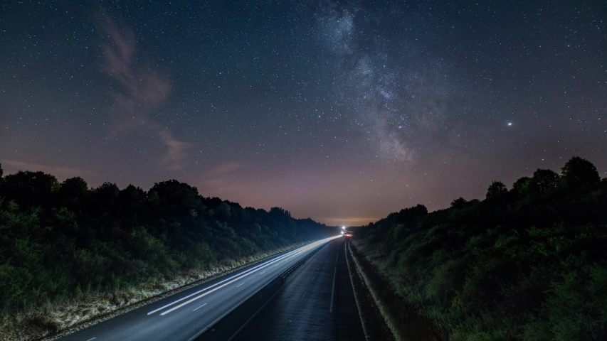 Time lapse milky way above highway