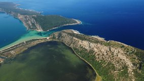 Aerial drone video of iconic castle in Navarino bay overlooking famous round sandy beach of Voidokilia and Gialova, Peloponnese, Greece