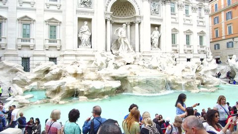 ROME, ITALY - CIRCA 2019: Tourists visit the famous, romantic baroque masterpiece Trevi Fountain in Rome, Italy. ProRes file, shot in 4K UHD.