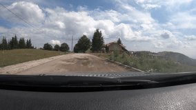 Mountain asphalt road on a sunny summer day with weekend houses - time lapse