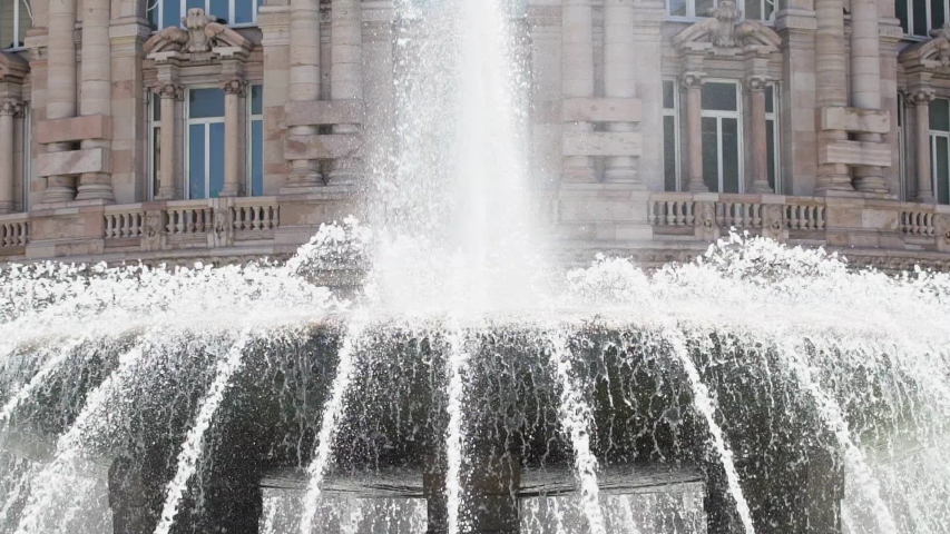 Genova fountain closeup slow motion. Piazza de Ferrari in Genoa, water jet. Ialian city, Europe. Holidays and vacation. Cine lens.