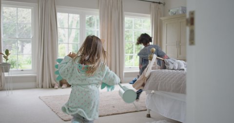 naughty children running through house cute little girl chasing her brother with watering can excited kids enjoying childhood game having fun on weekend morning wearing pajamas 4k