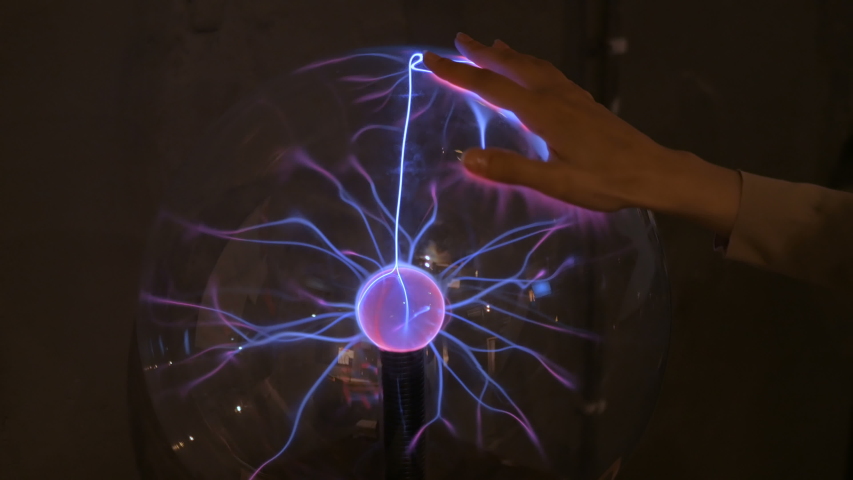 Interactive exposition in science museum. Woman hand touching plasma ball at futuristic exhibition - close up view. Electricity, experimental, technology and physics concept Royalty-Free Stock Footage #1034155211