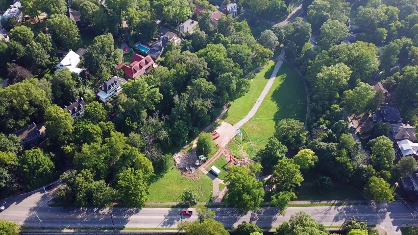 Aerial, tilt down, drone shot, over streets and buildings, in the suburbs of Louisville, on a sunny, summer day, in Kentucky, USA