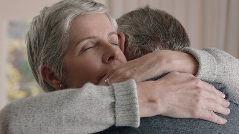 sad mature woman hugging husband sharing bad news to emotional wife couple embracing stressful retirement marriage problems 4k footage