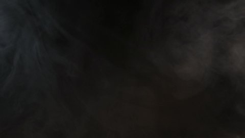 Atmospheric smoke Fog effect. VFX Element. Haze background. Abstract smoke cloud. Smoke in slow motion on black background. White smoke slowly floating through space against black background.