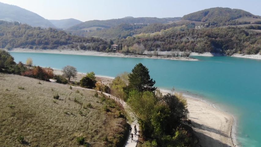 A stunning aerial view from the drone on a turquoise river, with white sand beaches and colorful woods around