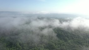 Slow flying over the misty clouds by early morning 4K drone video