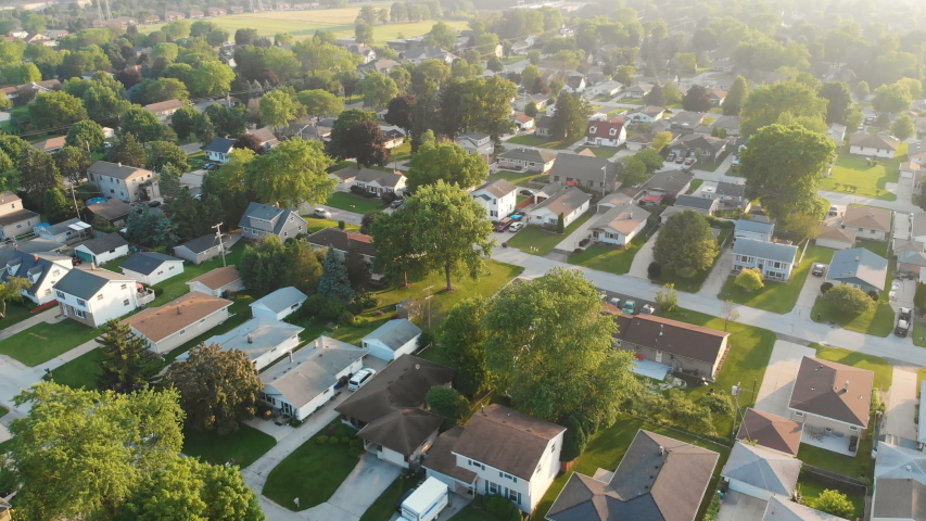 Aerial view of residential houses at summer. American neighborhood, suburb.  Real estate, drone shots, sunrise, sunlight, from above. Royalty-Free Stock Footage #1034181608