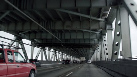 POV of cars driving on a bridge has a stark, futuristic look as they move forward in this smooth camera shot on a gimbal.  Filmed in 4K on a Canon C200. స్టాక్ వీడియో