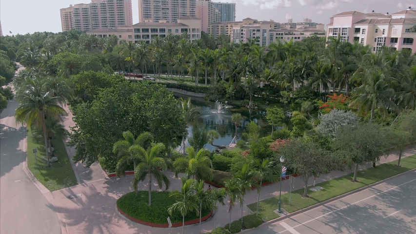Aerial: lake, fountain and tropical trees at Biscayne Lake Park on Key Biscayne, Miami, Florida 