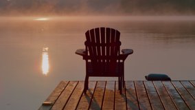 Muskoka chair on a dock at the cottage overlooking sunrise or sunset on the lake. Reflections shimmering in the water. Calm relaxing vacation. - Powered by Shutterstock - Get 15% off with code: PIKWIZARD15