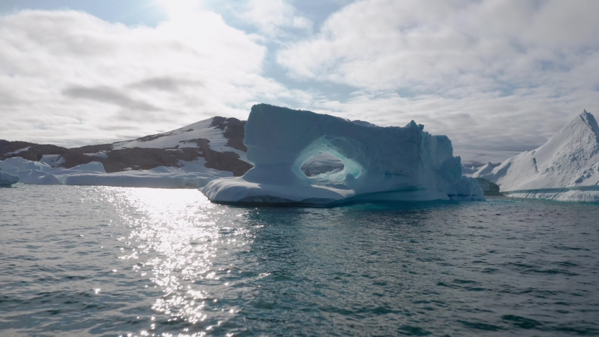 Flying through huge frozen iceberg hole in Greenland.