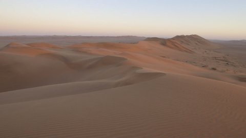 Pan across large Namib Desert red sand dunes wide angle