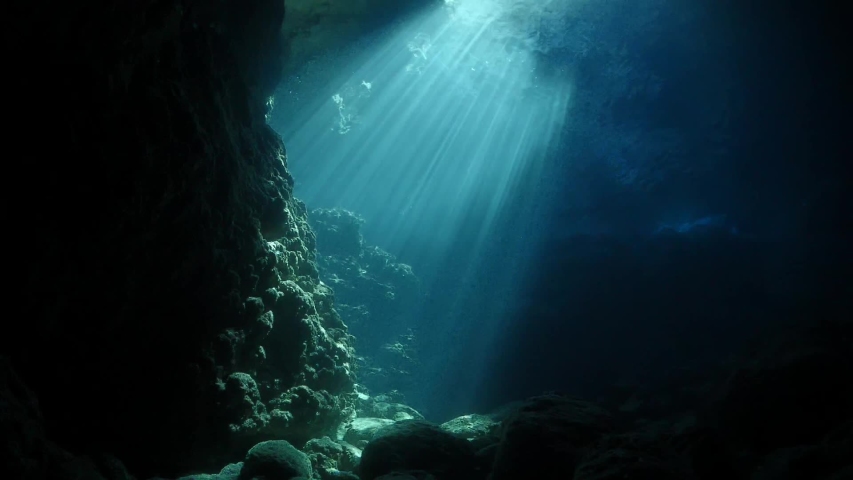 sun rays sun beams and sun shine underwater in cave beautiful light scenery in ocean scuba divers to see Royalty-Free Stock Footage #1034204060