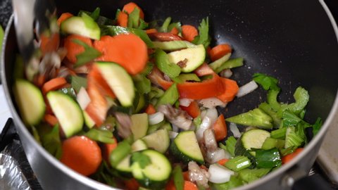 Stirring chop suey vegetables in the pan