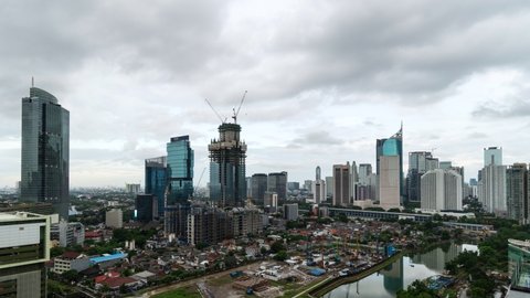 Jakarta, Indonesia - July 25 2019: Day to night timelapse of clouds moving above the Jakarta business district skyline in the very crowded Indonesian capital city