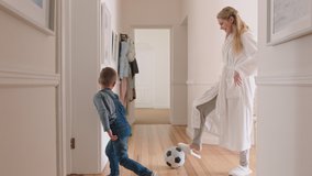 happy mother and son play with soccer ball at home little boy playing game with mom enjoying fun weekend together 4k footage - Powered by Shutterstock - Get 15% off with code: PIKWIZARD15