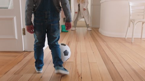 happy mother and son play with soccer ball at home little boy playing game with mom enjoying fun weekend together 4k footage