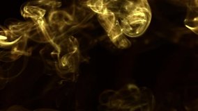 Slow motion ,video screensaver - Trickle golden smoke slowly rising graceful twists upward. Closeup, isolated on black background.