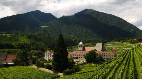 Spectacular view of Novacella Monastery surrounded by green wineyards in South Tyrol. Bressanone, Italy. Timelapse.