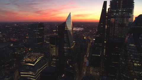 LONDON, UK - SEPTEMBER 9 , 2018: Aerial night view of London City on September 09 , 2018 in London, England. Aerial stock footage looking at over Tower Bridge, The Shard and The Gherkin