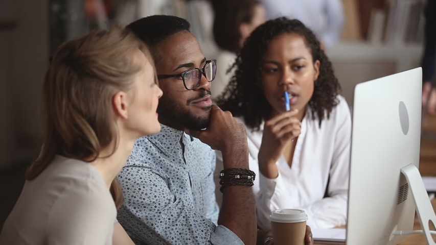 African male teacher mentor manager instructing diverse female trainees students interns explaining computer project, black leader teaching workers talk to colleagues learning online work in office Royalty-Free Stock Footage #1034217818