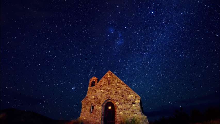 A lonely stone house in the night with the full moon orbiting above