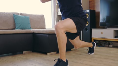 Man Doing Squats.Split Squats at Home Workout. Sports. Legs Close Up Shoot