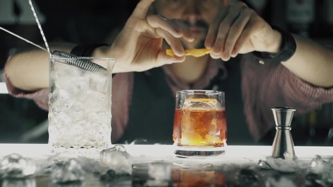 Barman make a cocktail on a bar