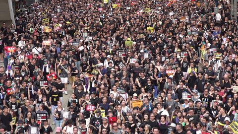 HONG KONG – 1 JULY 2019: People take part in huge (estimated over half a million) rally against controversial extradition law, Carrie Lam's role, and various other political, economic, social issues