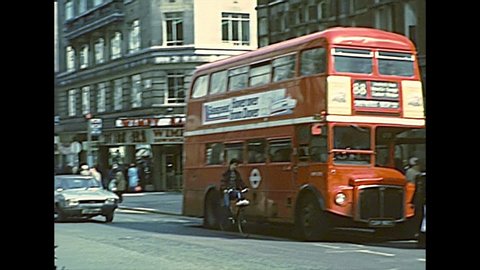 LONDON, UNITED KINGDOM - CIRCA 1977: vintage double-decker bus and car traffic in Soho, between Oxford Street and Regent Street. Archival of London in 1970s.