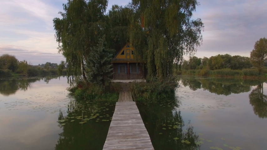 Hut on the island, aerial view of fairy tale house at beautiful sunrise