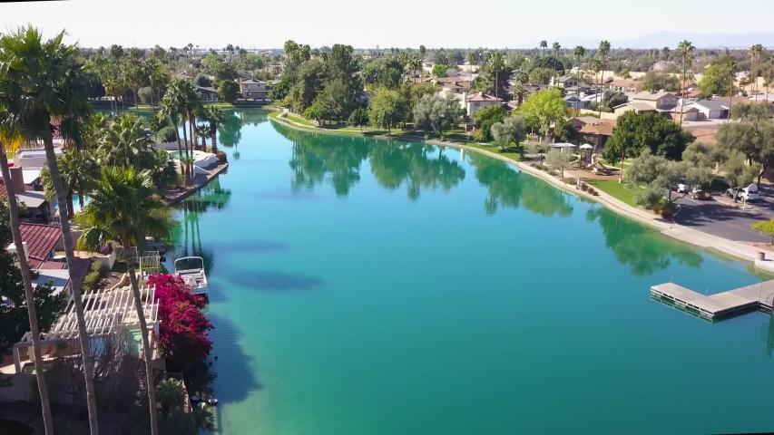 aerial view following a lake with home and boat docks in Arizona