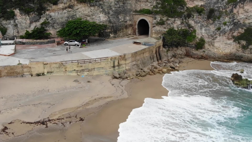 Aerial Slow Motion Footage hovering over a beach.