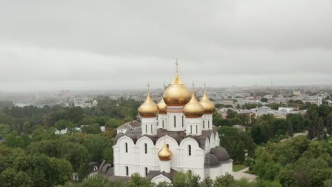 Golden Dome Church in Yaroslavl Russia, Golden Ring Touristic Route in Small Town Rural Russia Aerial Drone View Orbits Religious Building Surrounded by Green Trees