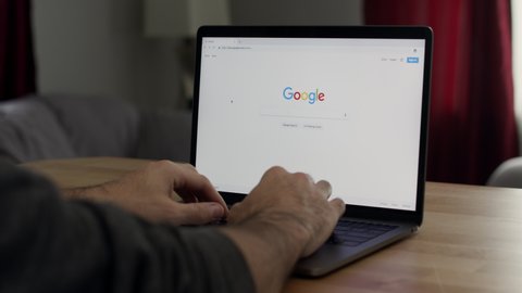 N/A , N/A / United States - 11 25 2018: A man uses Google to search for “Amazon Prime” and scrolls through the results