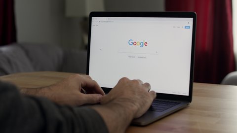 N/A , N/A / United States - 11 25 2018: A man uses Google to search for “Amazon” and scrolls through the results