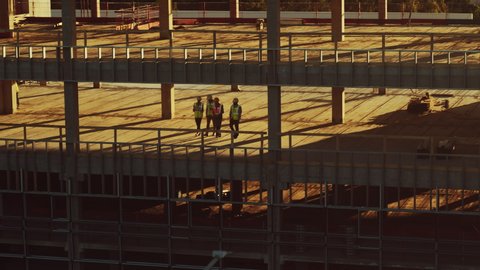 Aerial View: Diverse Team of Specialists Inspect Commercial, Industrial Building / Skyscraper Formwork Construction Site. Real Estate Project Lead by Civil Engineer, Investor, Architect and Worker