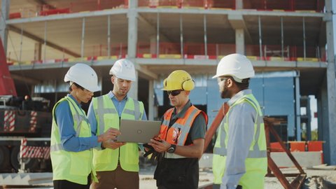 Diverse Team of Specialists Use Laptop Computer on Construction Site. Real Estate Building Project with Civil Engineer, Architectural Investor, Businesswoman and Worker Discussing Plan Details