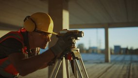 Inside of the Commercial / Industrial Building Construction Site: Professional Engineer Surveyor Takes Measures with Theodolite, Using Digital Tablet Computer - Powered by Shutterstock - Get 15% off with code: PIKWIZARD15