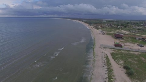Aerial view of Azov sea coast near cape Kazantip, Crimea. Long beach on overcast day.