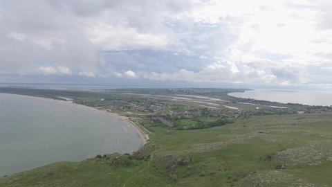 Aerial view of green hills on cape Kazantip, sea of Azov, Crimea on overcast day.