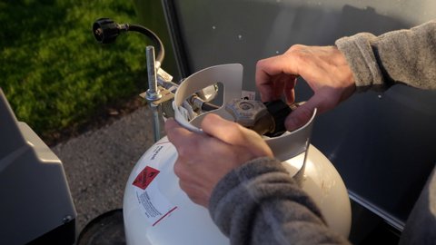 Close up installing propane tanks on RV for camping