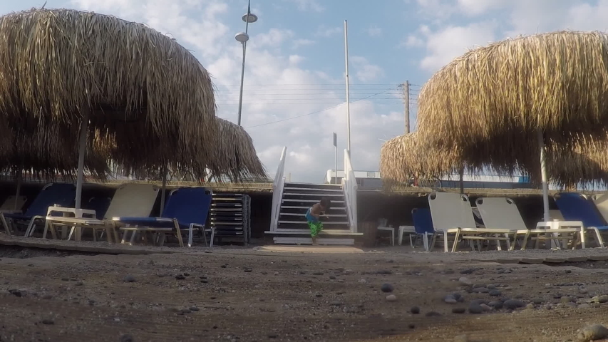 Kid approach from stairway to the beach
